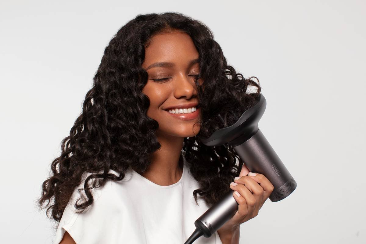 woman using hair pick trends technique on curly hair with wide-tooth pick